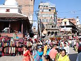 Kathmandu 05 02-1 Indra Chowk Merchants sell pashmina and other fabric shawls and other cloth goods next to the shikira-style Shiva temple in Indra Chowk in Kathmandu.
